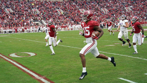 Nov 23, 2019; Tuscaloosa, AL, USA; Alabama Crimson Tide defensive back Xavier McKinney (15) returns an interception for a touchdown during the first quarter against the Western Carolina Catamounts at Bryant-Denny Stadium.